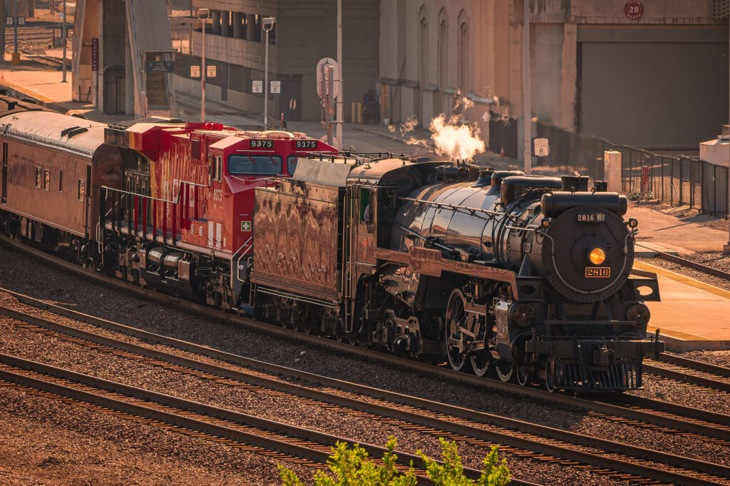 train on track near buildings and trees sunny day 2025 02 11 18 48 19 utc 1 Clayton Industries – Advanced Steam Boiler Technology